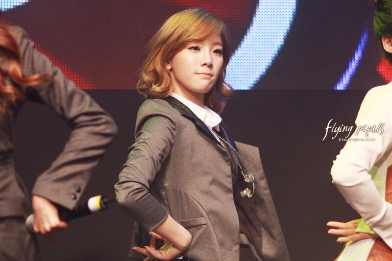 woman in suit on stage