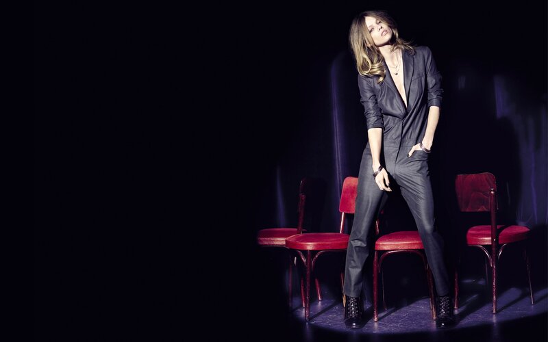 woman in suit on stage