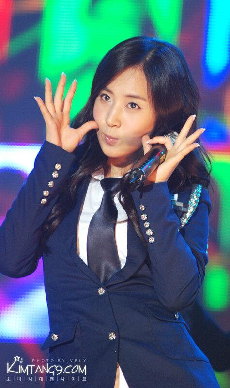 woman in suit on stage