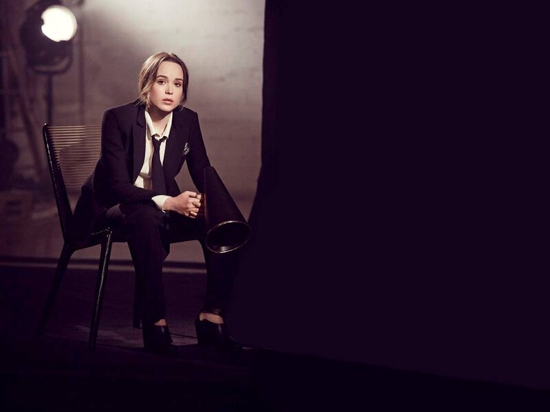Woman in Suit Sitting — Black, Dramatic, Photograph