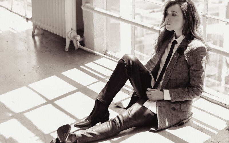 Woman in Suit Sitting — Black, Dramatic