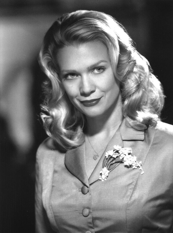 woman in suit with flower brooch