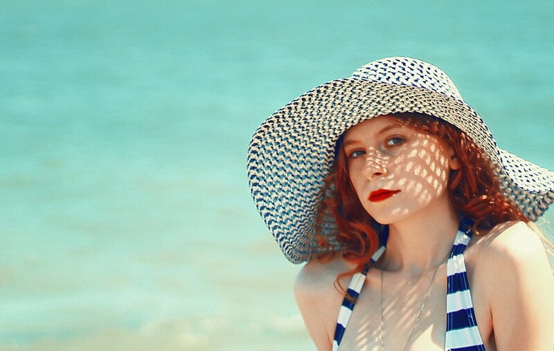 woman in sun hat at beach