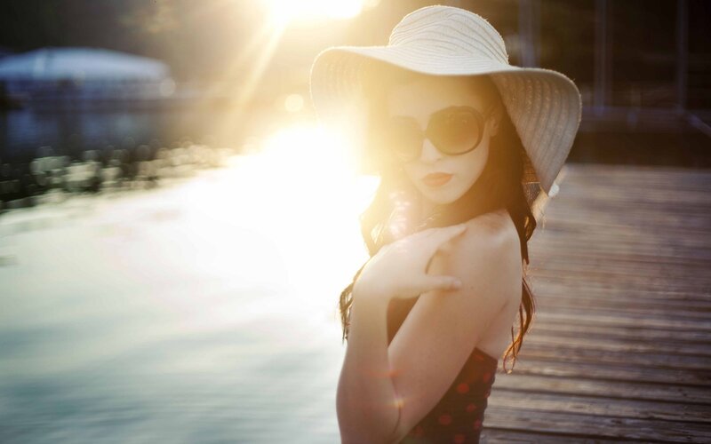 woman in sun hat at sunset