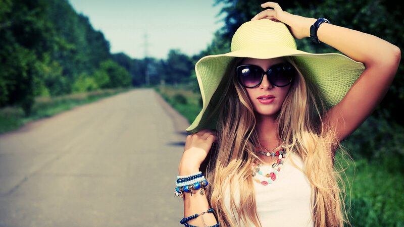 woman in sun hat on road