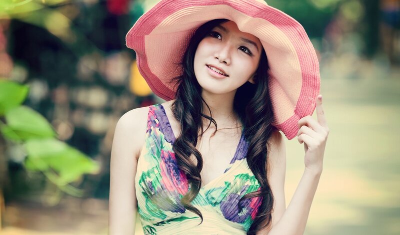 woman in sun hat smiling