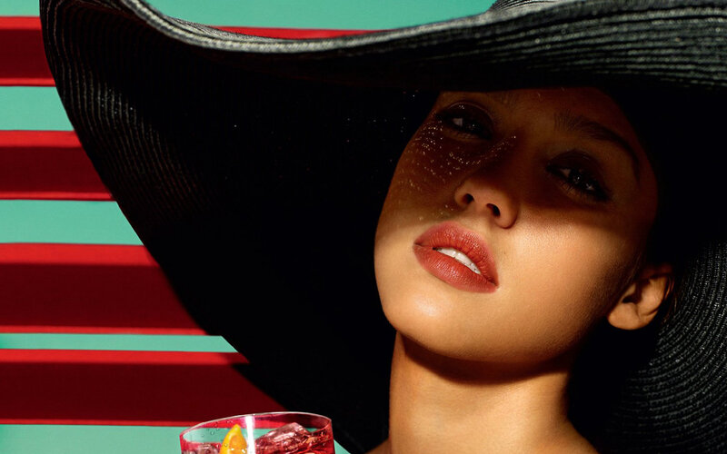 woman in sun hat with drink