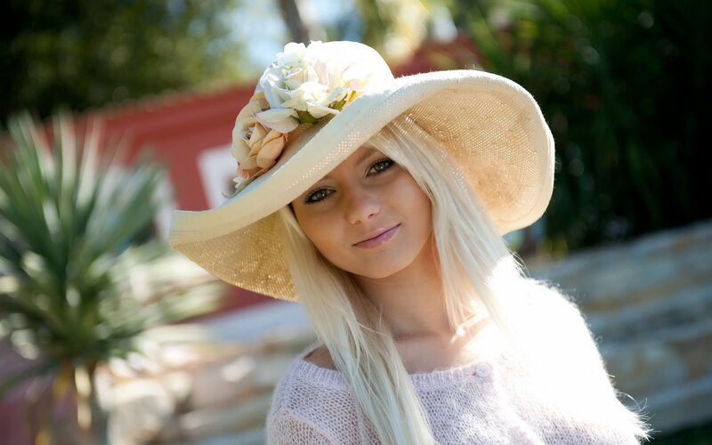 woman in sun hat with flowers