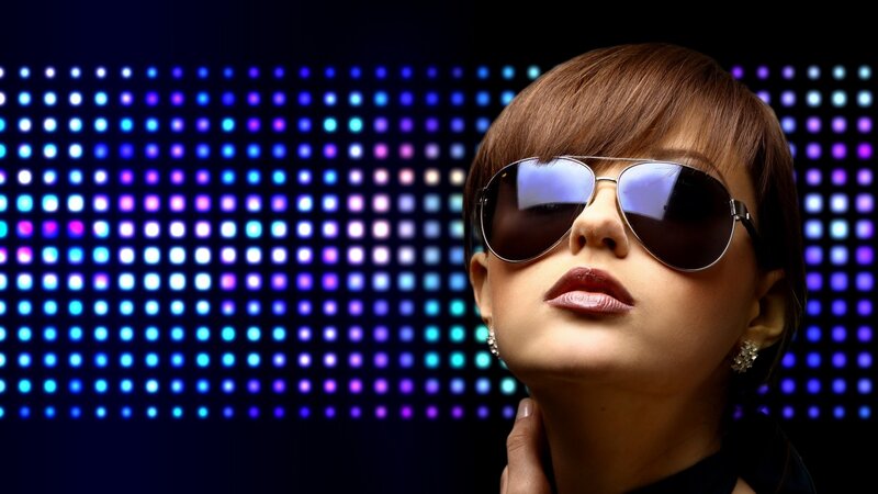 woman in sunglasses against lights