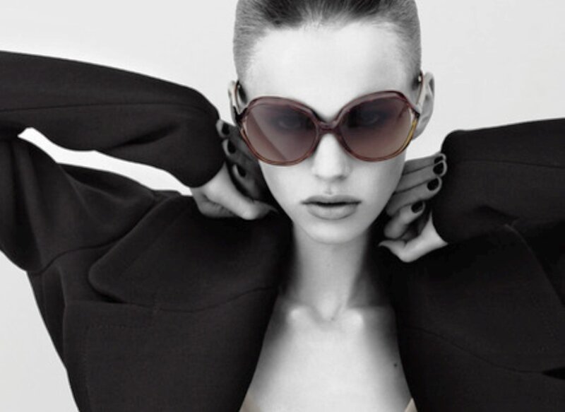woman in sunglasses and black coat