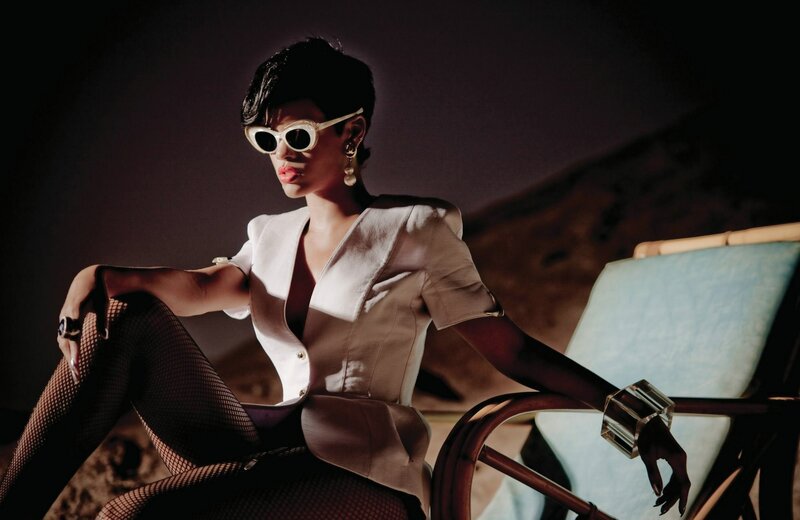 woman in sunglasses and fishnet tights
