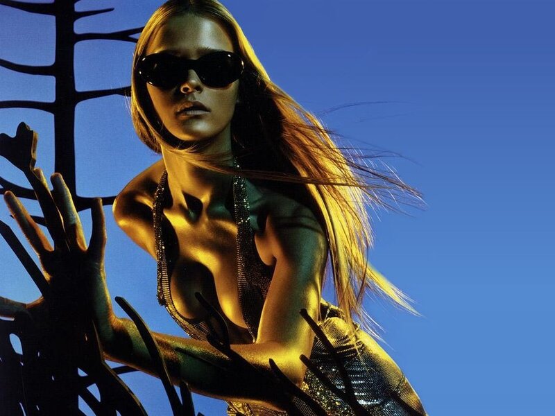 woman in sunglasses and gold outfit