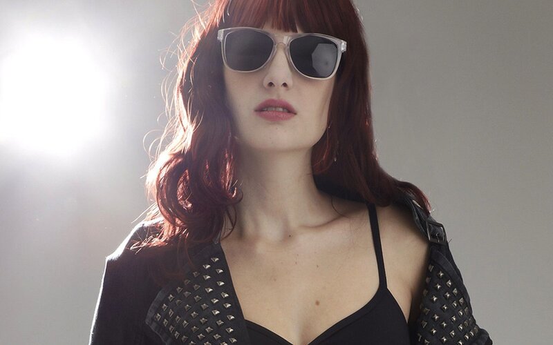 woman in sunglasses and studded jacket