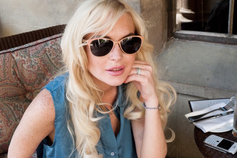 woman in sunglasses at outdoor table