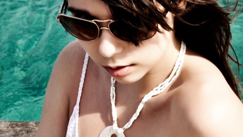 woman in sunglasses by pool