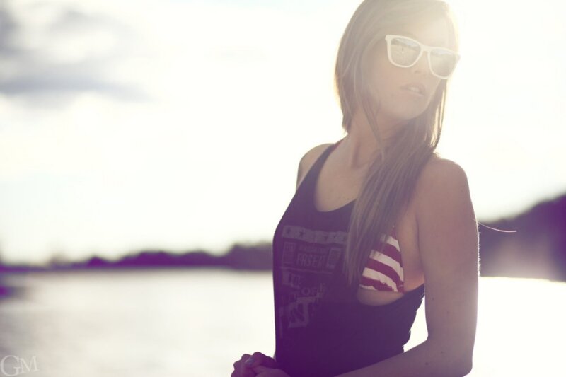 woman in sunglasses by water