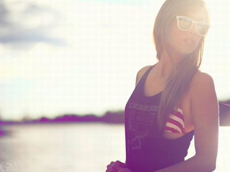 woman in sunglasses by water