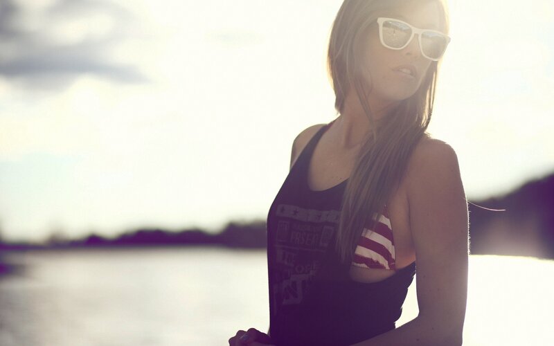 woman in sunglasses by water