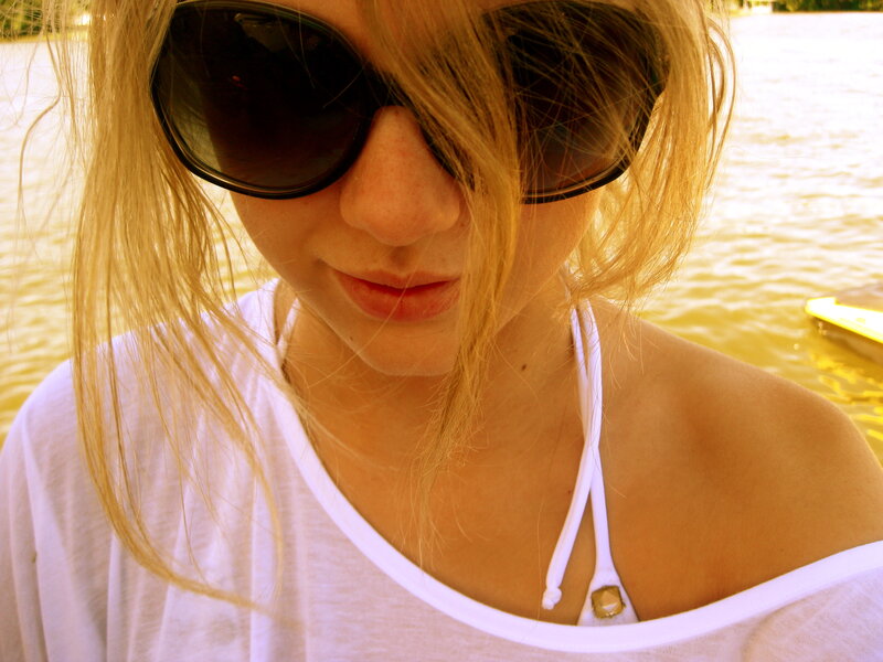 woman in sunglasses by water