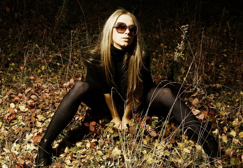 woman in sunglasses in autumn leaves