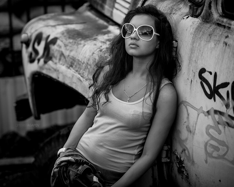 woman in sunglasses leaning on car