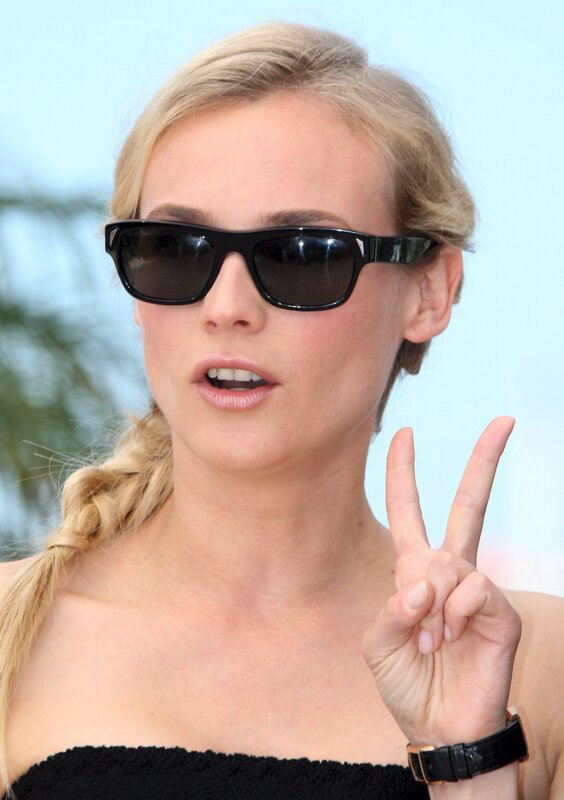 woman in sunglasses making peace sign