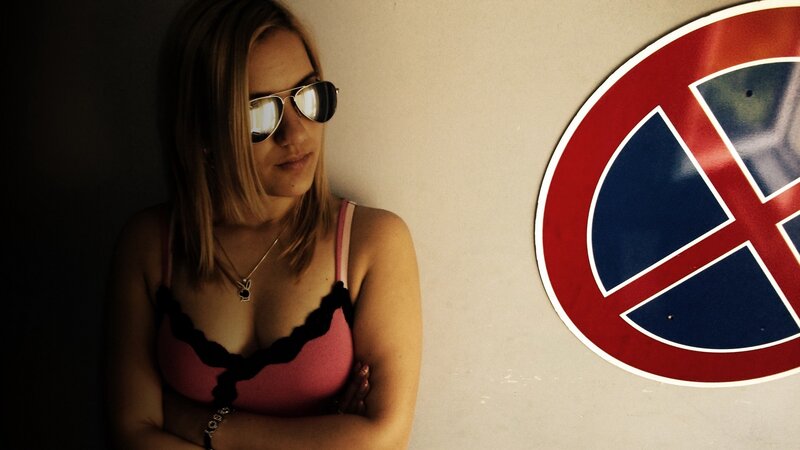 Woman in sunglasses near sign