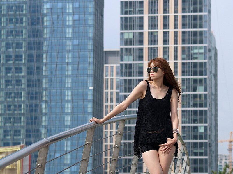 Woman in sunglasses on a bridge