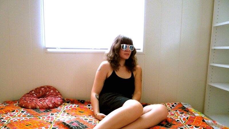woman in sunglasses on bed