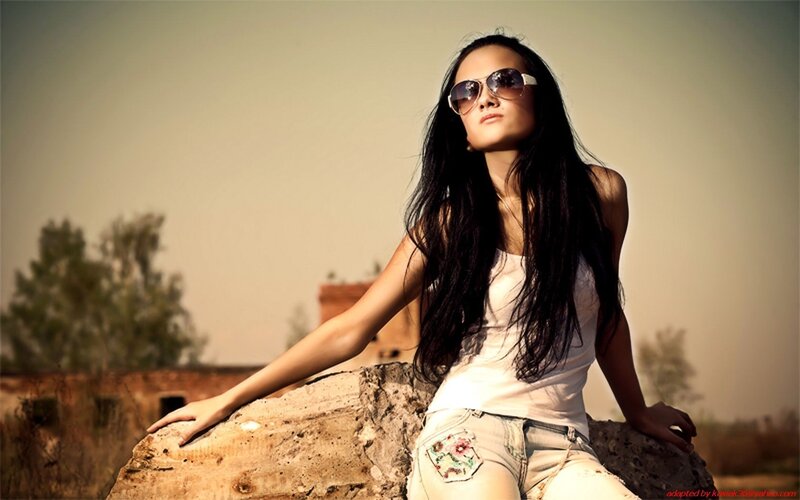 woman in sunglasses on rock