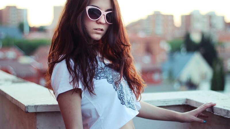 woman in sunglasses on rooftop