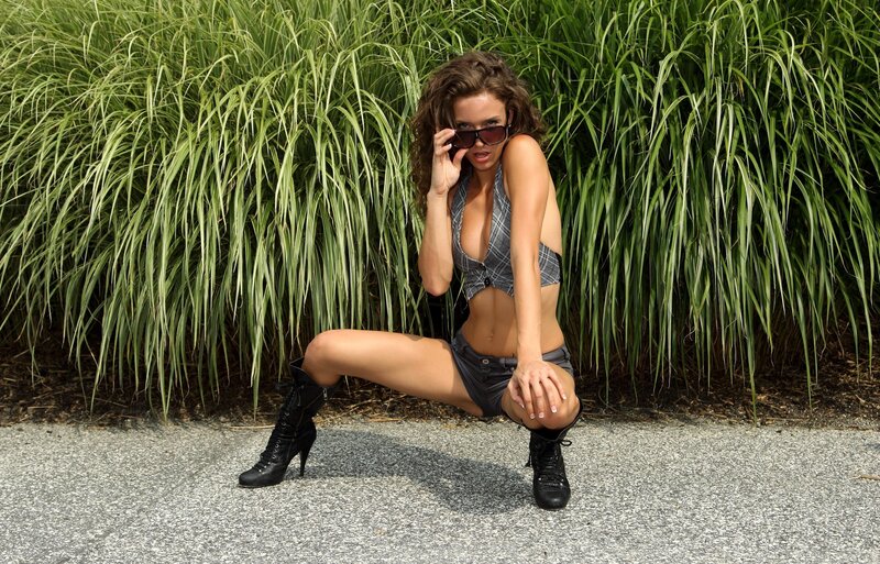 woman in sunglasses posing outdoors