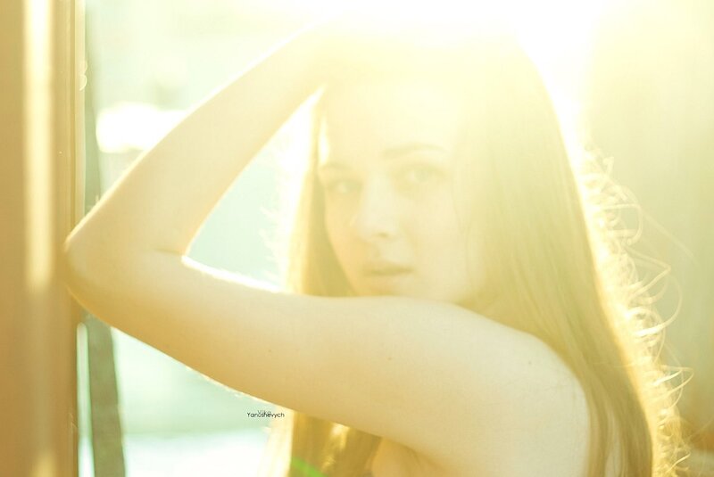 woman in sunlight by window