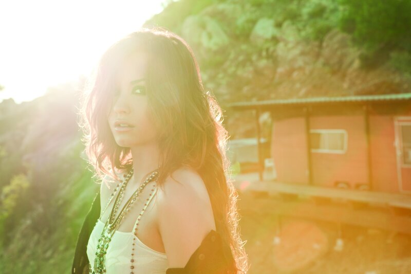 woman in sunlight near cabin