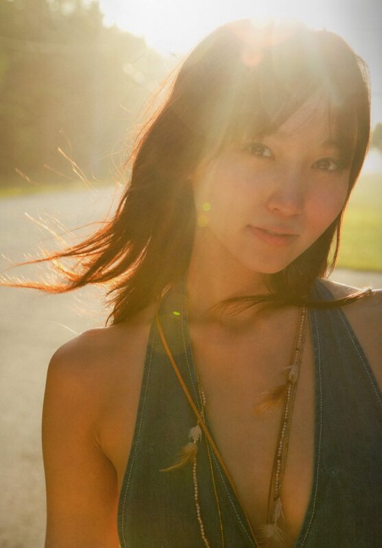 woman in sunlight with feather necklace