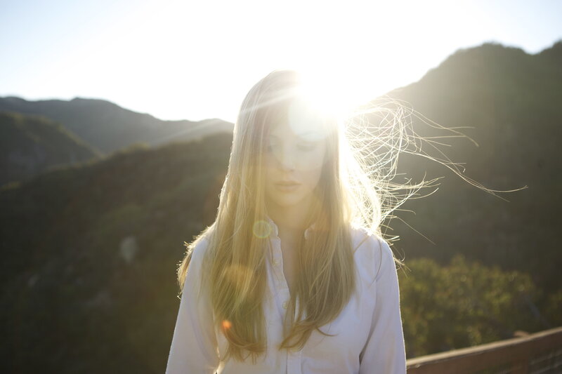 woman in sunlight with mountains