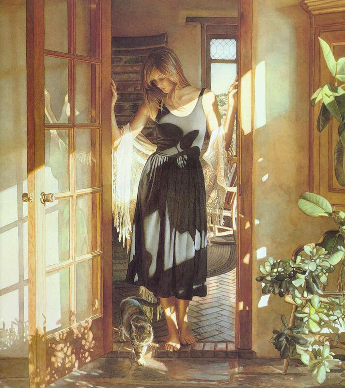 Woman in sunlit doorway with cat