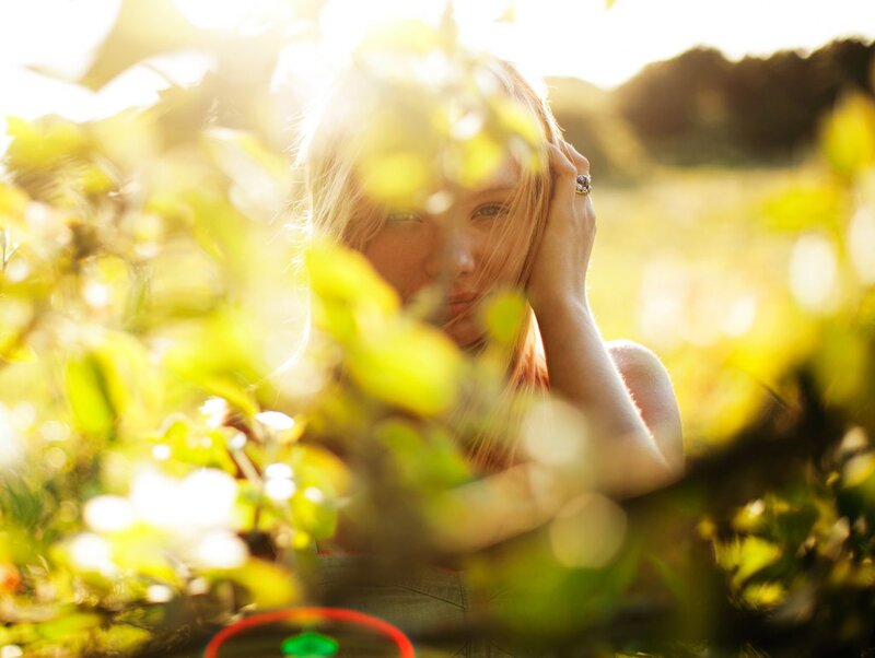 woman in sunlit foliage