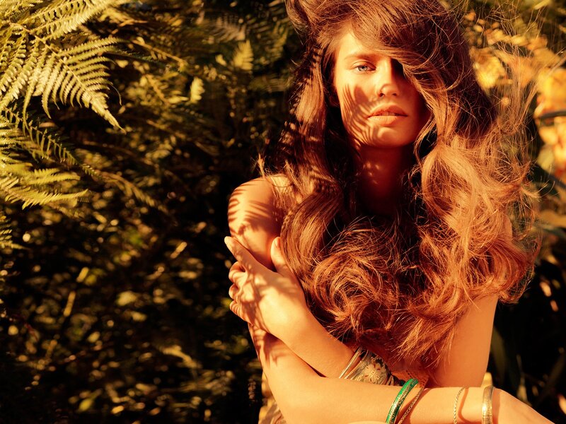 woman in sunlit foliage