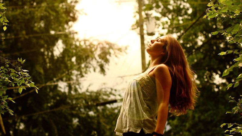 woman in sunlit forest