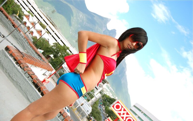 woman in superhero costume on rooftop