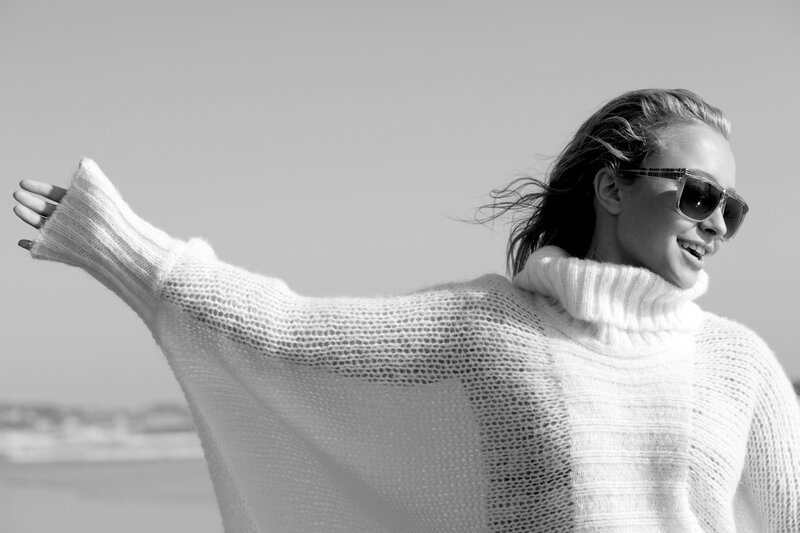 woman in sweater at beach