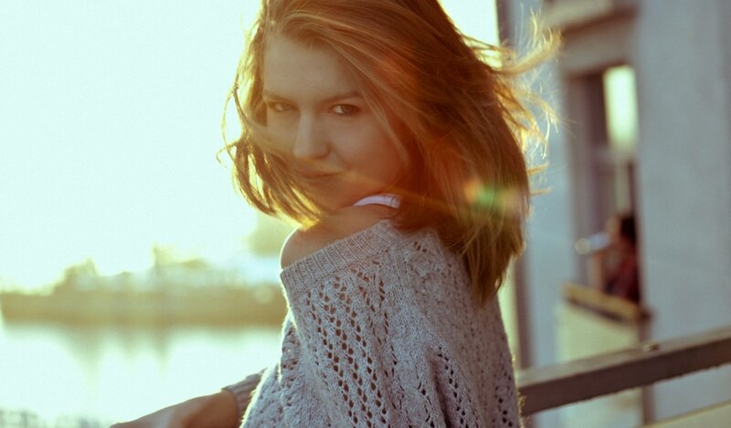 woman in sweater at sunset