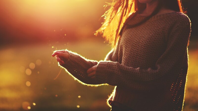 woman in sweater at sunset