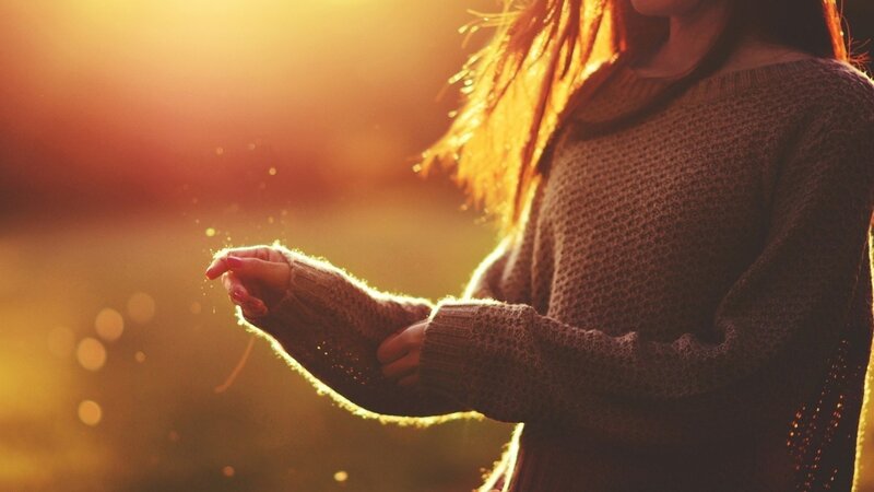 woman in sweater at sunset