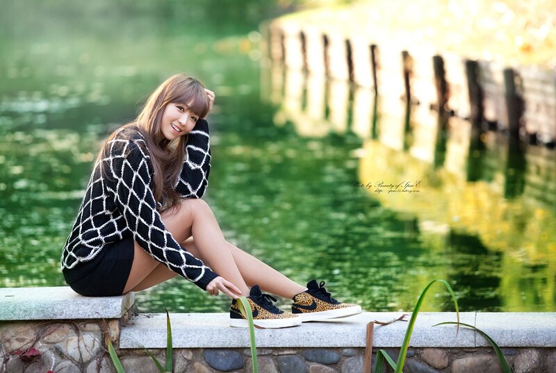 Woman in sweater by pond