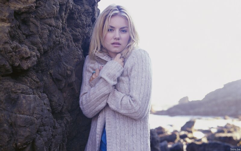 Woman in sweater by the sea