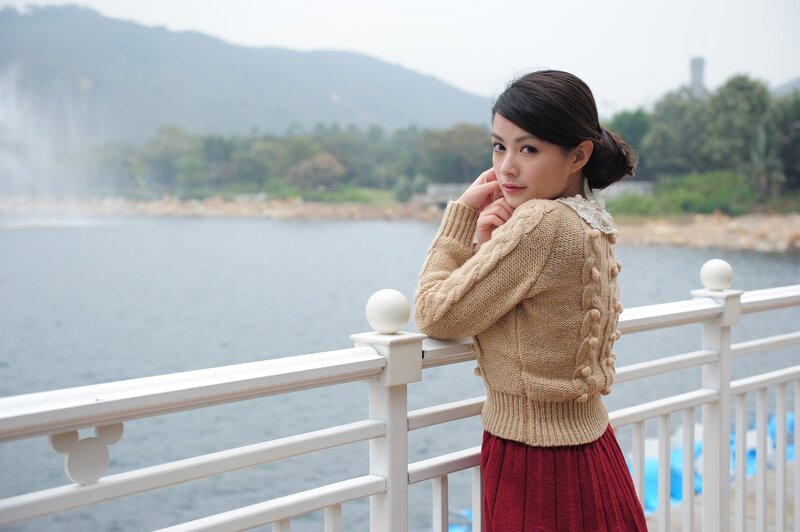 Woman in sweater by the water