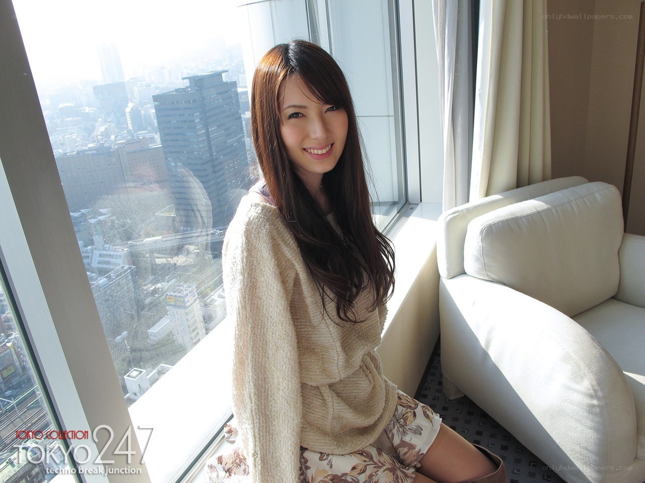 Woman in sweater by window