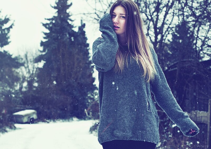 woman in sweater during snowfall